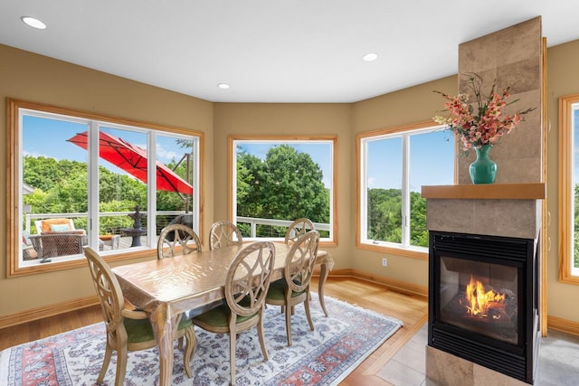 19115 Vogel Farm Trl, Eden Prairie, MN 55347 - dining room featuring a large fireplace, light wood finished floors, and recessed lighting