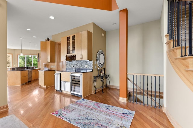 19115 Vogel Farm Trl, Eden Prairie, MN 55347 - kitchen featuring wine cooler, dishwasher, light wood-type flooring, decorative backsplash, and recessed lighting