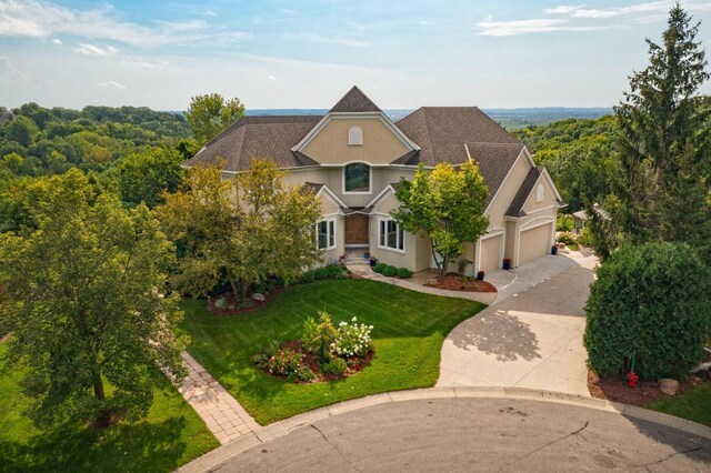 19115 Vogel Farm Trl, Eden Prairie, MN 55347 - view of front facade with stucco siding, driveway, a front yard, and a garage