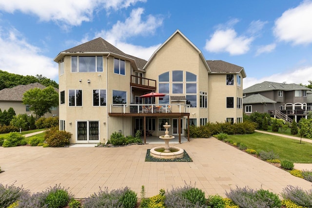19115 Vogel Farm Trl, Eden Prairie, MN 55347 - rear view of house featuring a balcony, a yard, and stucco siding