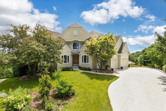 19115 Vogel Farm Trl, Eden Prairie, MN 55347 - view of front of house with stucco siding, concrete driveway, a front lawn, and an attached garage