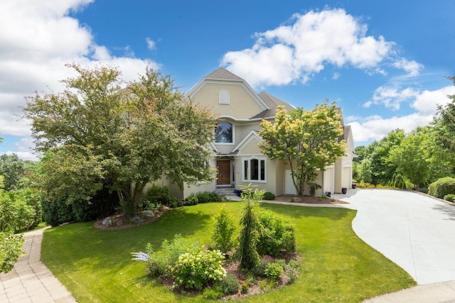 19115 Vogel Farm Trl, Eden Prairie, MN 55347 - view of front facade with concrete driveway, stucco siding, a front yard, and a garage