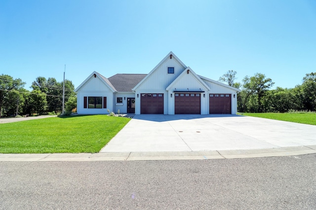 modern farmhouse with a garage and a front lawn