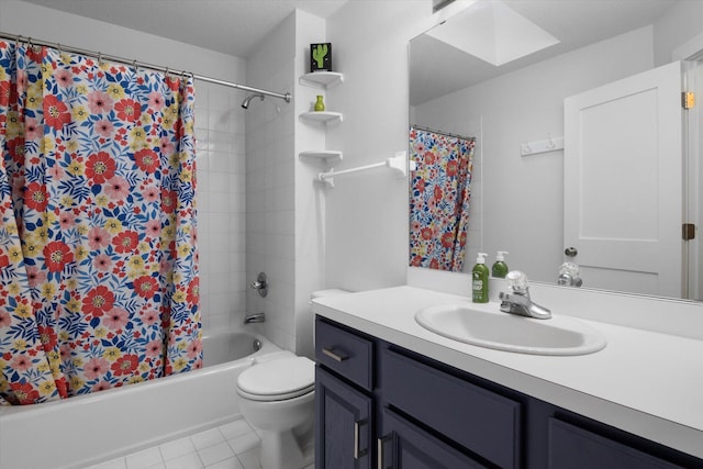 full bathroom with tile patterned floors, toilet, a skylight, vanity, and shower / bath combination with curtain