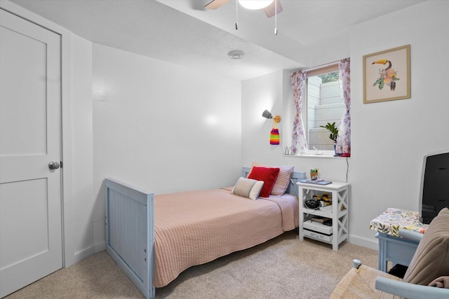 bedroom featuring light colored carpet and ceiling fan