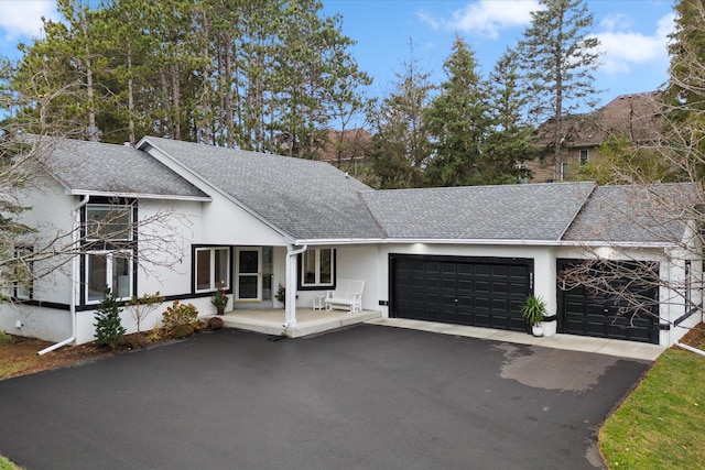 single story home with a garage and covered porch