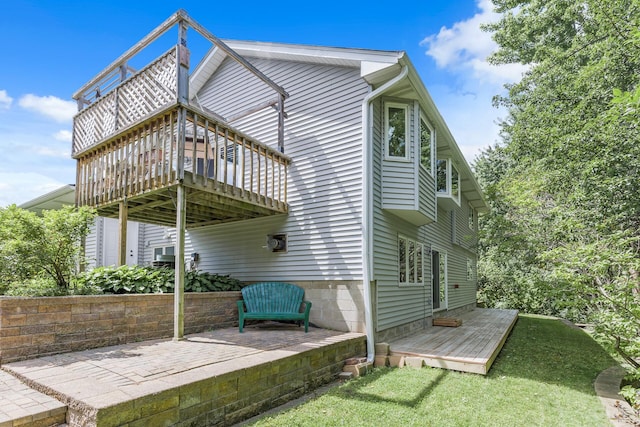 view of side of home featuring a deck and a patio