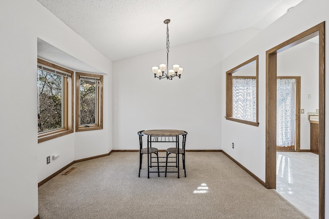 dining space featuring lofted ceiling, carpet flooring, visible vents, baseboards, and an inviting chandelier