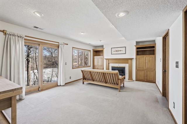 bedroom with access to exterior, visible vents, light colored carpet, and a tile fireplace