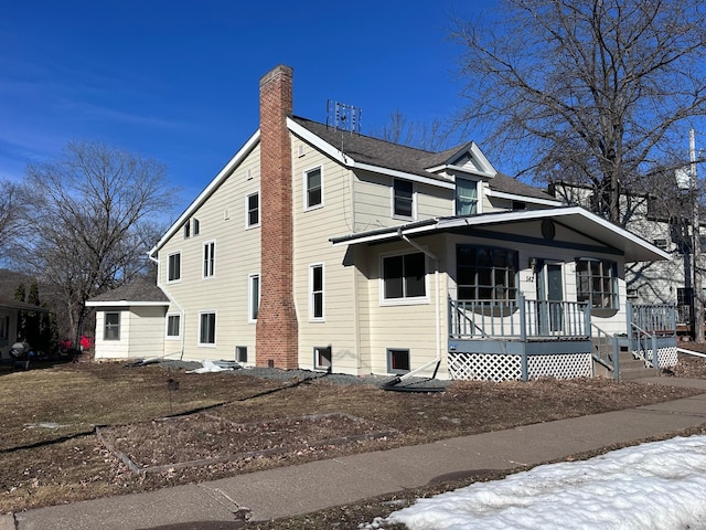 view of front of property featuring covered porch and a chimney