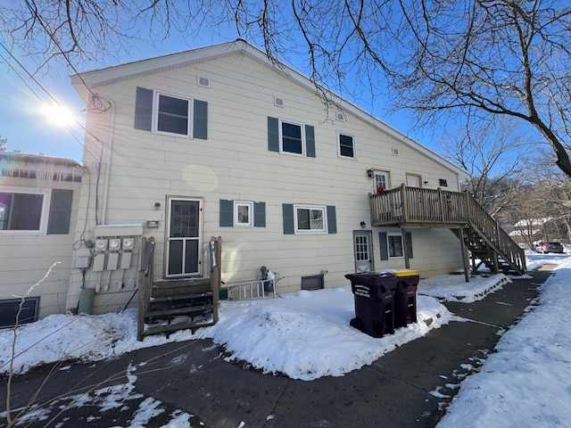 view of snow covered rear of property