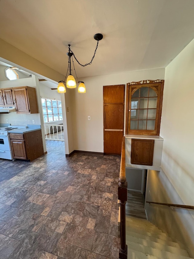 unfurnished dining area featuring stone finish flooring and baseboards