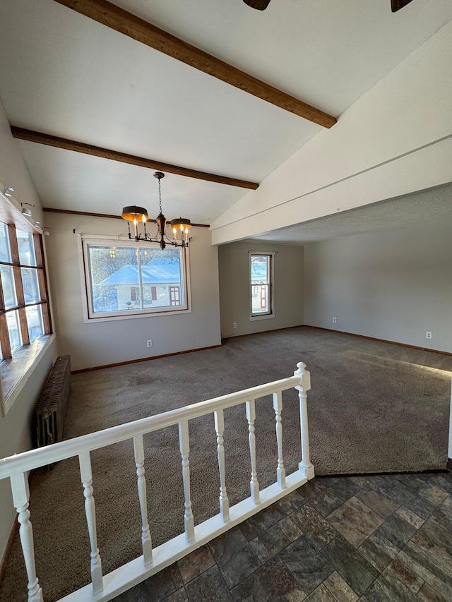 empty room featuring baseboards, radiator, vaulted ceiling with beams, dark colored carpet, and a chandelier