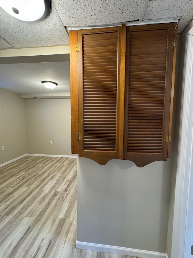 room details with baseboards and wood finished floors