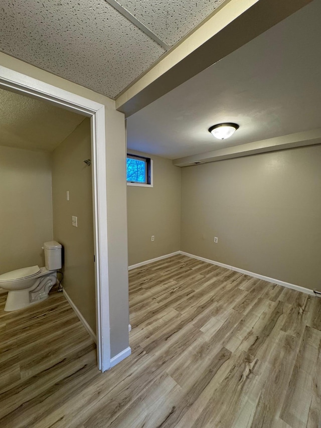 below grade area with light wood-type flooring and baseboards