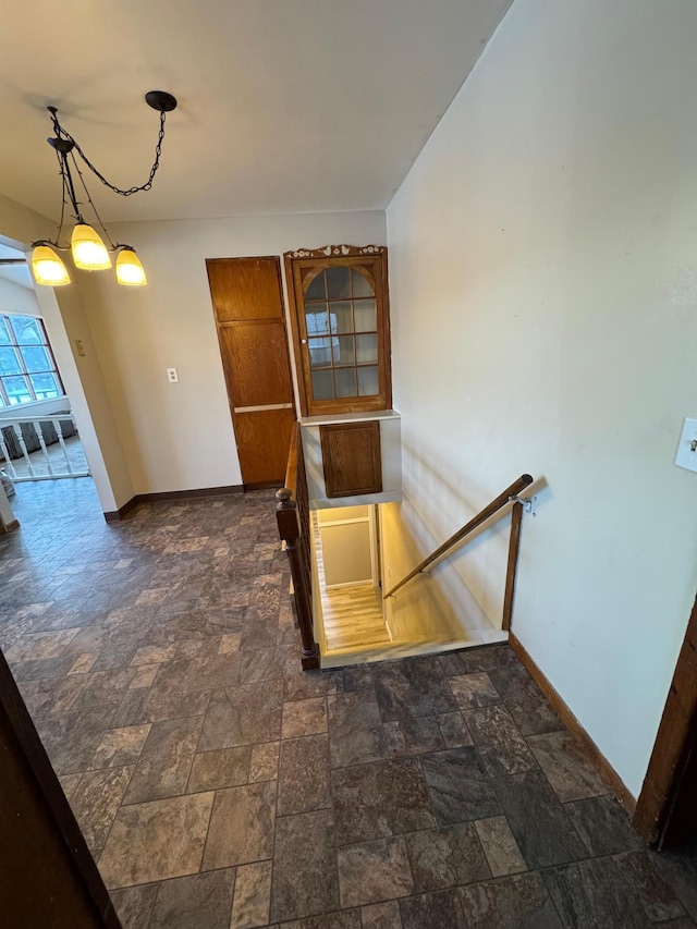 interior space with stone finish flooring and baseboards