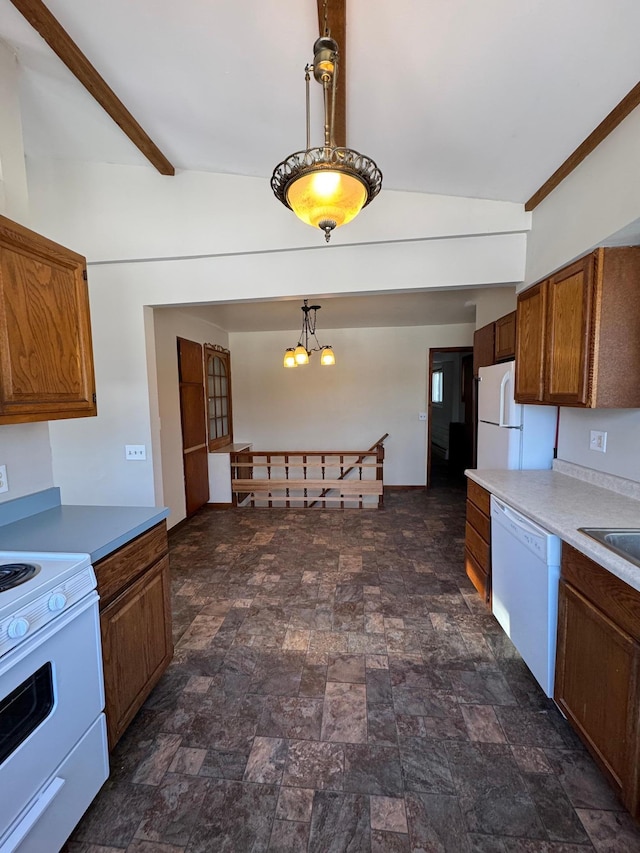 kitchen with vaulted ceiling with beams, white appliances, hanging light fixtures, light countertops, and stone finish flooring