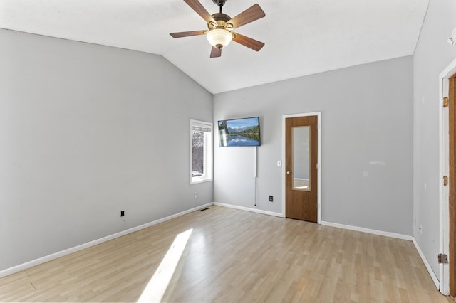 unfurnished bedroom featuring vaulted ceiling, light wood-type flooring, and baseboards