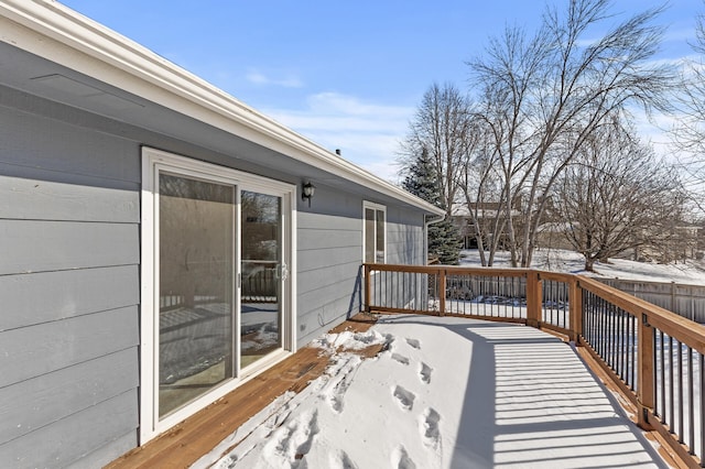 snow covered deck with fence