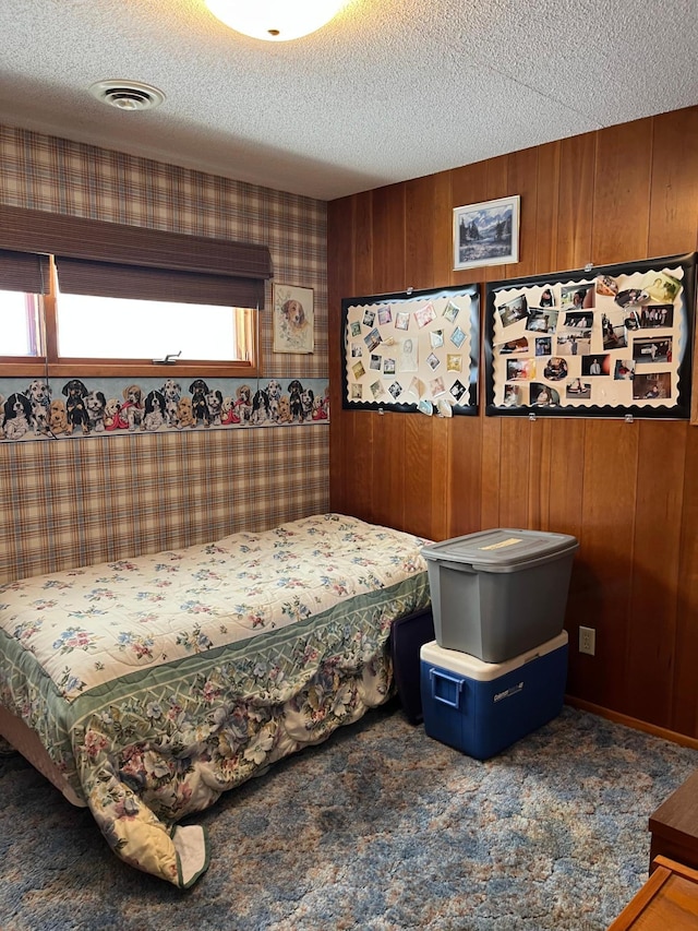 bedroom with a textured ceiling and carpet floors