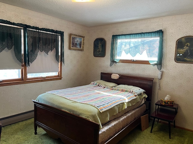 bedroom with carpet flooring, a baseboard heating unit, and a textured ceiling