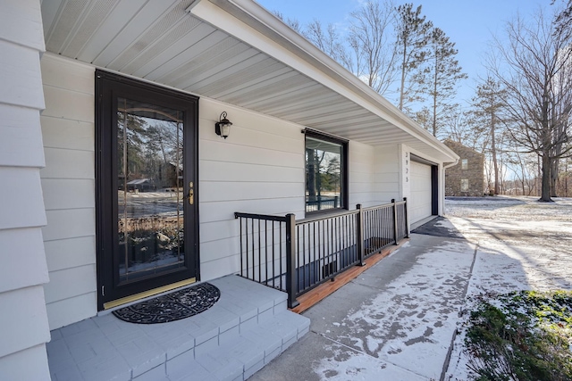 property entrance with a porch and a garage