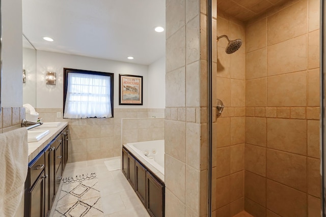 bathroom with tile walls, vanity, independent shower and bath, and tile patterned floors