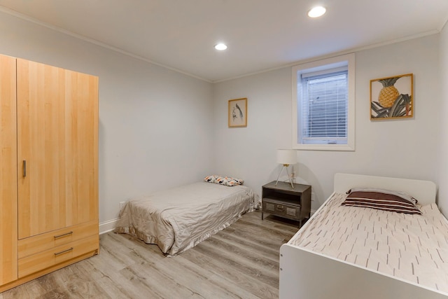 bedroom featuring crown molding and wood-type flooring