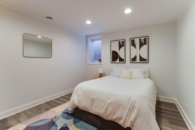 bedroom featuring dark wood-type flooring and crown molding