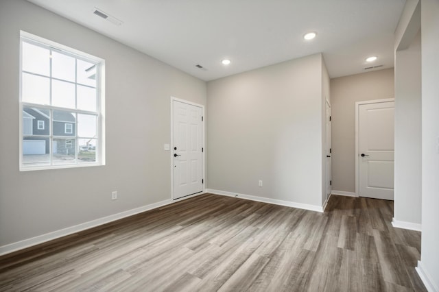 unfurnished room with hardwood / wood-style floors