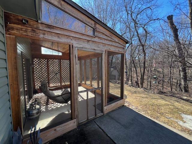 view of patio with a sunroom