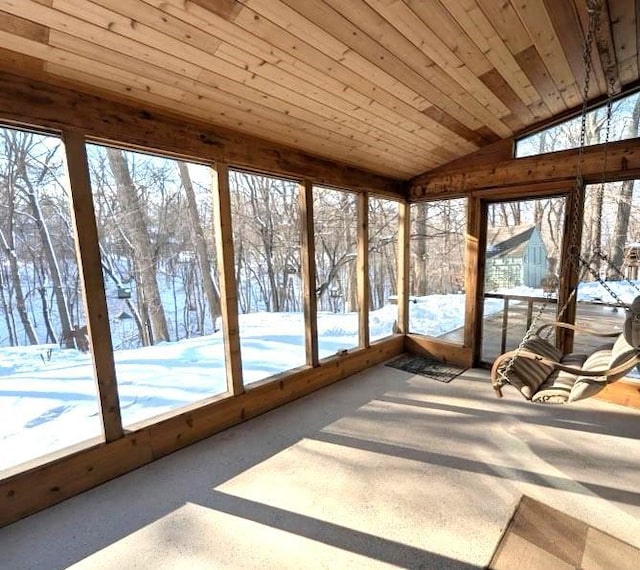 unfurnished sunroom featuring a wealth of natural light, lofted ceiling, and wooden ceiling