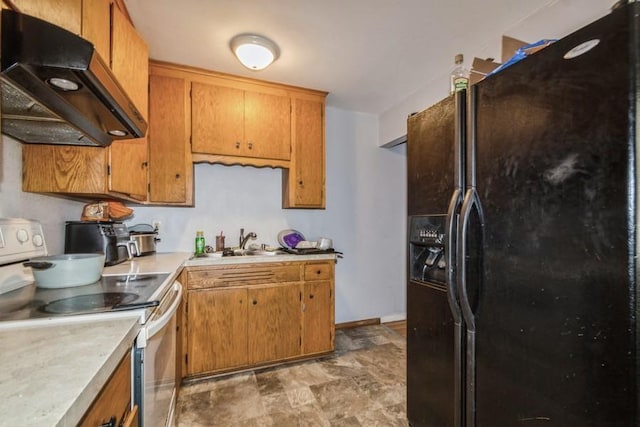 kitchen with extractor fan, black fridge, electric range oven, and sink