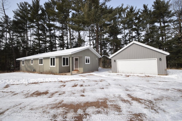 exterior space featuring a garage and an outbuilding