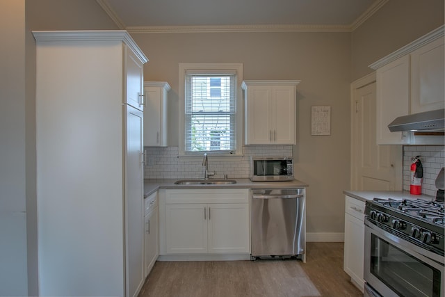 kitchen featuring stainless steel appliances, sink, white cabinets, and light hardwood / wood-style flooring