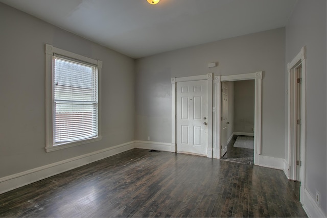 unfurnished bedroom with dark hardwood / wood-style floors