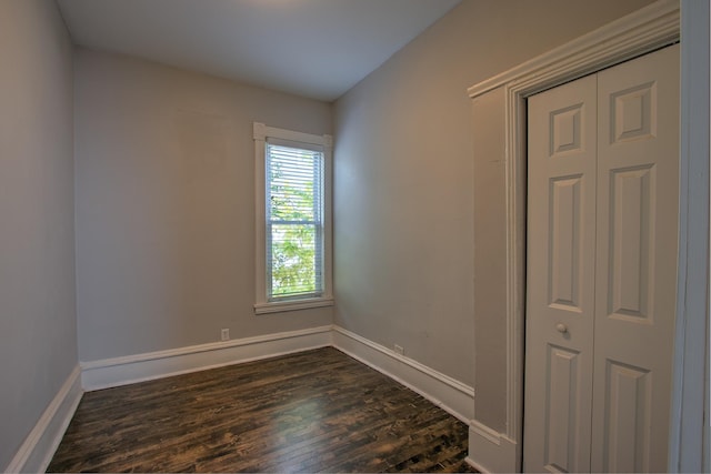 spare room with dark wood-type flooring