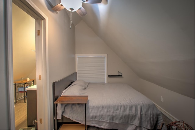 bedroom featuring ceiling fan, lofted ceiling, and wood-type flooring