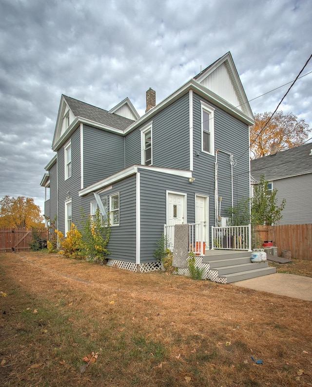 back of property featuring a lawn