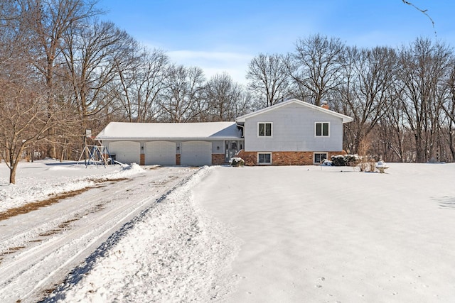 view of front of home with a garage and brick siding