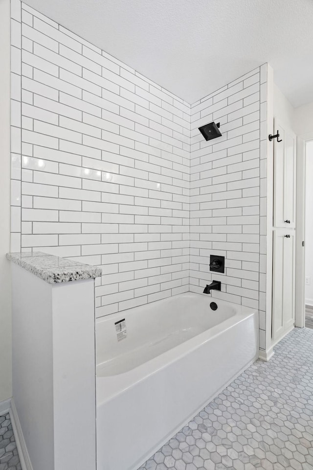 full bath with  shower combination, baseboards, and tile patterned floors