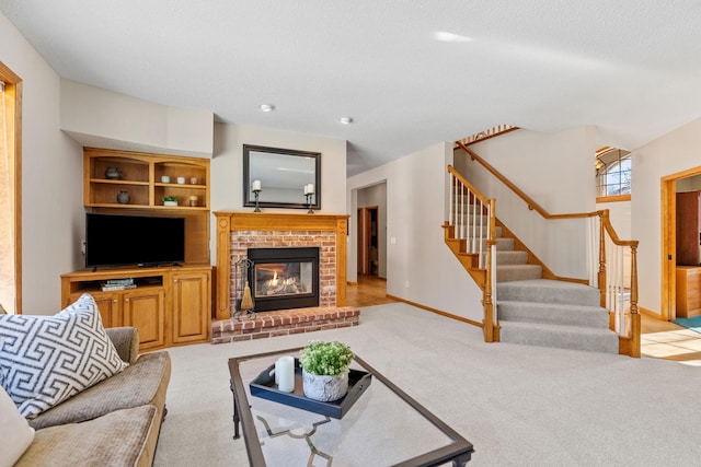 living room with a brick fireplace, light colored carpet, stairway, and baseboards