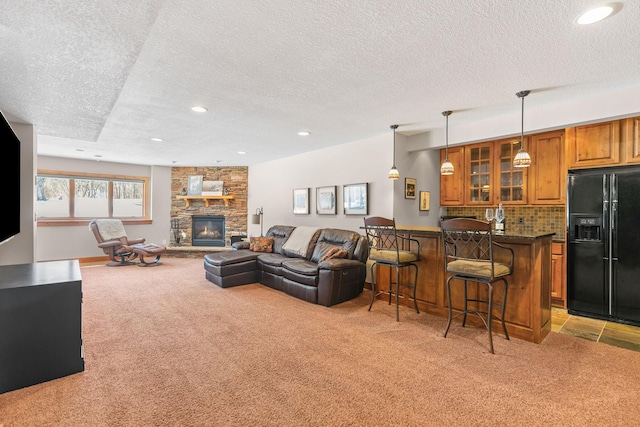 living area featuring light carpet, a fireplace, indoor bar, and recessed lighting