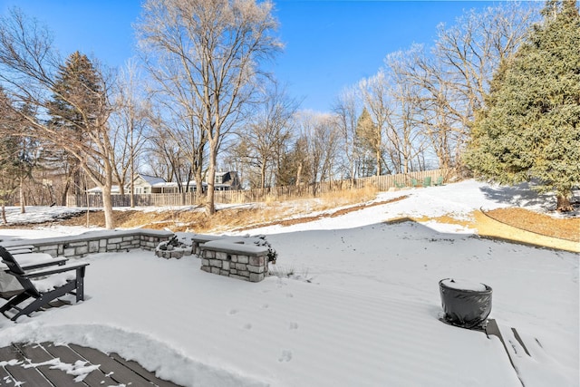 yard layered in snow with fence