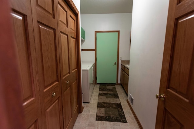 hallway featuring washer and dryer and visible vents