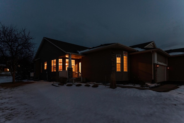 view of snow covered exterior with a garage