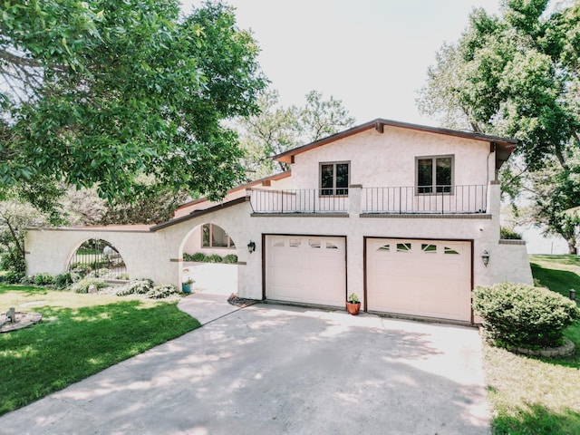 7324 21st Ave NW, Pennock, MN 56279 - mediterranean / spanish-style house featuring a balcony, stucco siding, concrete driveway, a garage, and a front yard