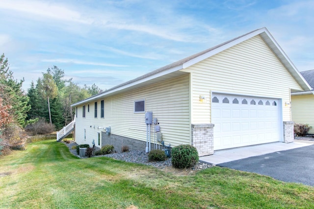 view of side of property featuring central AC unit, aphalt driveway, and a yard