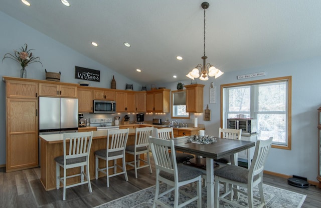 dining space with lofted ceiling, a chandelier, recessed lighting, baseboards, and dark wood-style floors