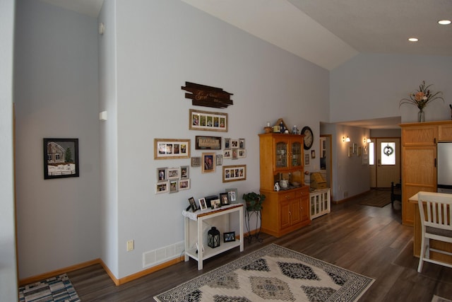 interior space with dark wood-style flooring, recessed lighting, visible vents, vaulted ceiling, and baseboards